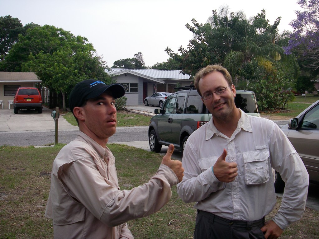 Sean Fitzgibbon and Jeff Fabiszewski give thumbs up outdoors beside parked vehicles in 2007