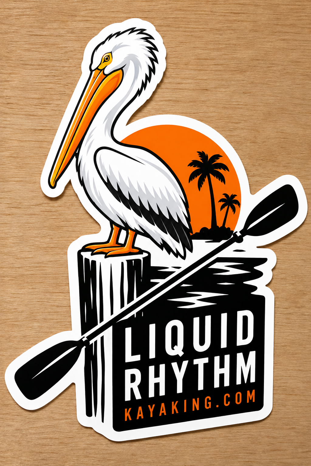 Illustrated American white pelican on a piling beside an orange sunset, palm silhouettes, a black kayak paddle, and Liquid Rhythm Kayaking website lettering.